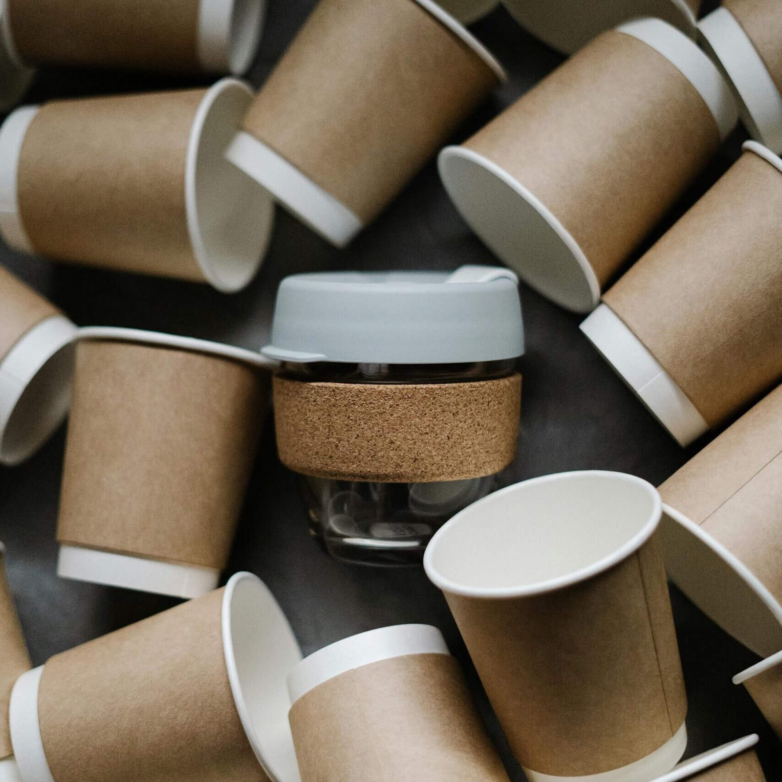 Overhead view of eco-friendly paper and reusable cups promoting zero waste lifestyle.